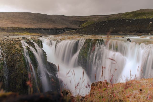Breathtaking Waterfall Flowing Through Rugged Landscape at Dusk - Download Free Stock Photos Pikwizard.com