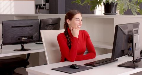 Smiling Professional Engaging in Video Conference Call at Office Desk