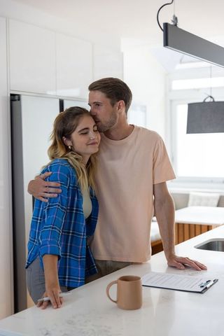 Couple Embracing in Modern Kitchen Sparking Romantic Connection