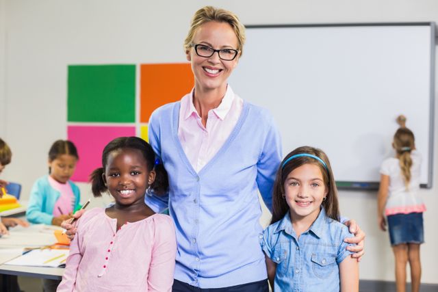 Portrait of smiling teacher and kids standing together with arm around - Download Free Stock Photos Pikwizard.com