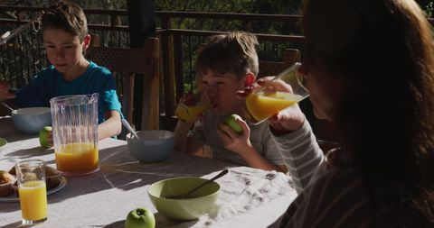 Family Enjoying Breakfast with Fresh Juice Outdoors - Download Free Stock Images Pikwizard.com