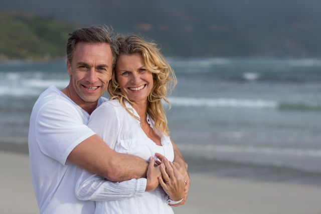 Romantic Mature Couple Embracing on Beach - Download Free Stock Photos Pikwizard.com