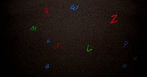 Floating multicolored alphabet letters on gray background