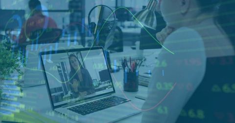 Remote team video meeting with laptop and financial data overlay in modern office