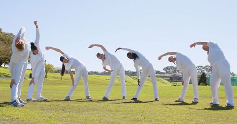 Diverse Women Group Stretching in Park Outdoor Fitness session