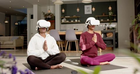 Women Using VR Headsets for Meditation in Cozy Home Interior