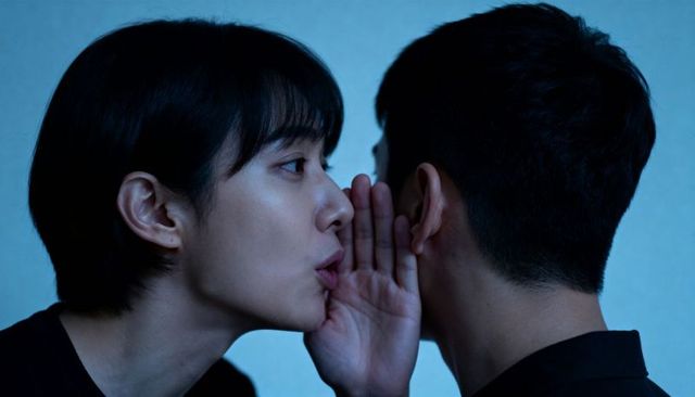 Whispering closeup: woman leaning toward man, intimate blue minimal portrait