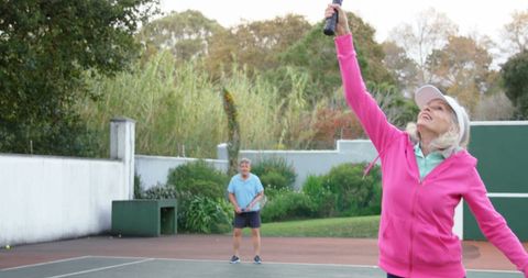 Active senior couple enjoying tennis outdoors