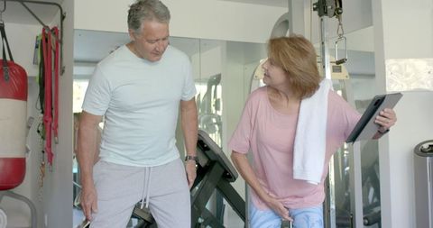 Senior Couple Laughing During Home Workout in Fitness Area