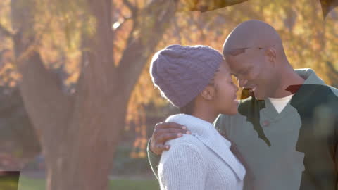 Romantic Couple Smiling and Embracing in Autumn Park