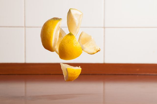 Floating Lemon Slices Suspended in Air Against Kitchen Tiles - Download Free Stock Photos Pikwizard.com