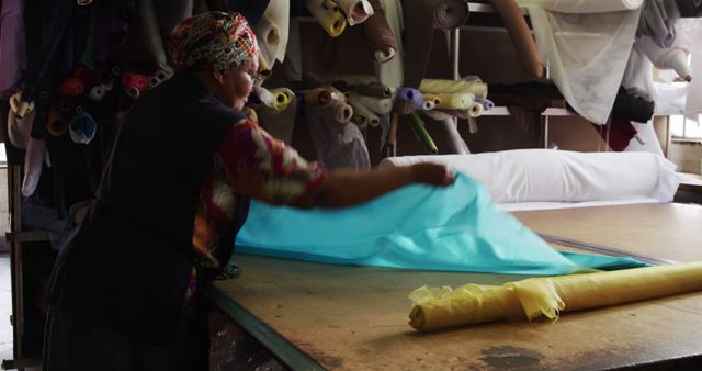 Female Textile Worker Organizing Fabric in Workshop - Download Free Stock Images Pikwizard.com