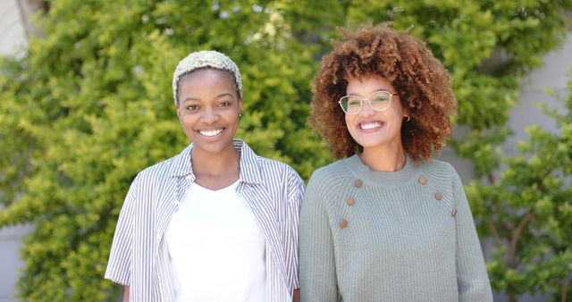 Two Smiling Women Standing Outdoors with Greenery - Download Free Stock Images Pikwizard.com