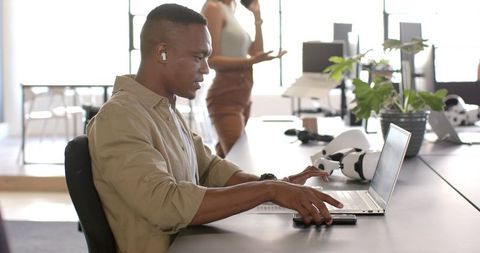 Young Professional with Laptop in Modern Workspace Stay Productive - Download Free Stock Images Pikwizard.com