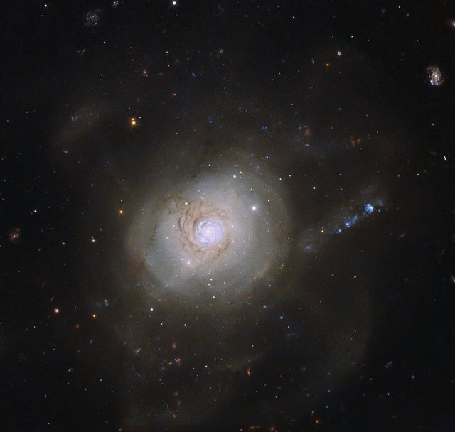 Unique image of spiral galaxy NGC 7252 taken by NASA/ESA Hubble Space Telescope. Features loops resembling electronic orbits of an atom, remnants of a galactic collision from a billion years ago. Widely useful in contexts like astronomy research, space education, galaxy formation studies, inspiring science content, cosmic photography displays, educational materials about galactic evolution, and exploratory science fiction backdrops.