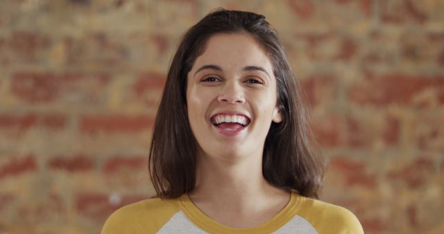 Happy Young Woman Smiling Against Brick Wall Background - Download Free Stock Images Pikwizard.com