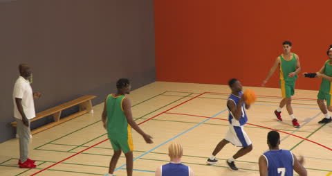 Dynamic Basketball Match with Focused Coaching Underway