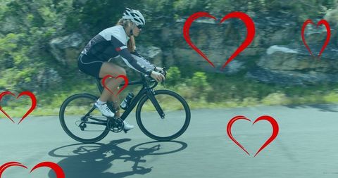 Female cyclist in motion with heart overlays illustrating passion for cycling