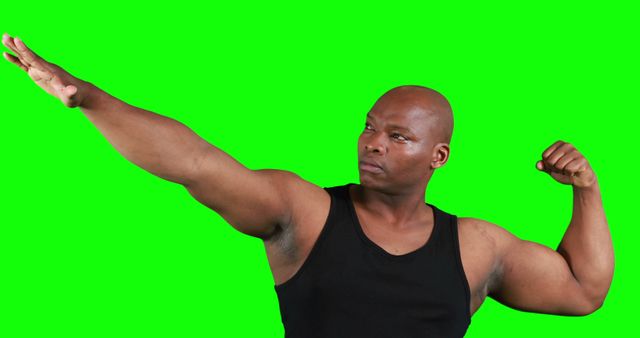 Man flexing muscular arm on a green screen background, suggesting confidence and strength. Suitable for fitness, health, athletic content, advertisements, or promotional materials needing isolated subject for easy background change.