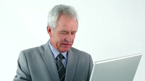 Senior Business Professional Using Laptop on White