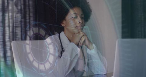 Female doctor using laptop with futuristic hud overlay for telehealth consultation