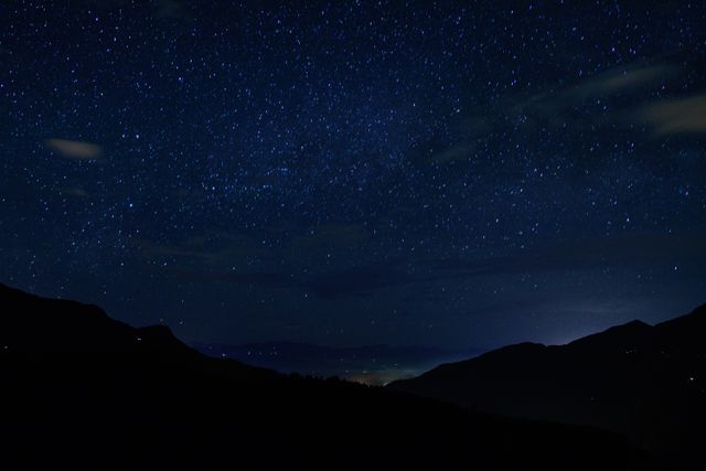Beautiful view of a star-filled night sky over a mountain range. Ideal for use in astronomy websites, travel blogs, or nature photography collections. Great for illustrating concepts of tranquility, wilderness, and the beauty of the natural world.