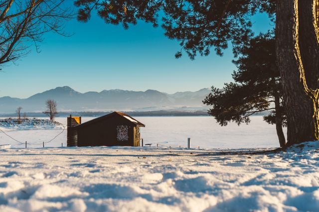 Wooden Cabin in Pristine Snowy Landscape with Mountain Backdrop - Download Free Stock Photos Pikwizard.com