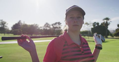 Confident Female Golf Player Posing on Sunny Golf Course - Download Free Stock Images Pikwizard.com