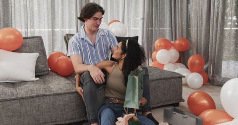 Couple Celebrating Birthday with Gifts in Modern Living Room