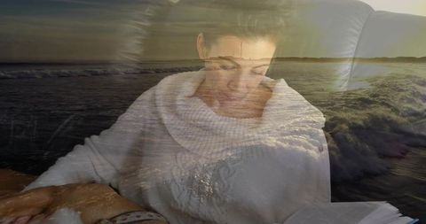 Woman reading in sweater with calming ocean sunrise overlay