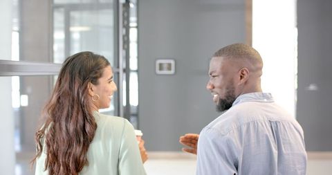 Business Professionals Collaborating in Corporate Office Hallway