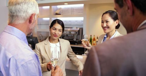Business Partners Celebrating with Champagne at Bar