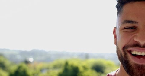Happy Man Enjoying View from Balcony on Sunny Day