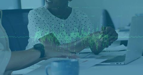 Team collaborating on data visualization and analytics using laptop in modern office