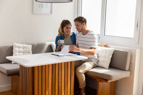 Couple reviewing documents in cozy dining nook