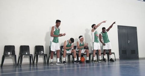 Energetic basketball team cheering with dynamic team spirit