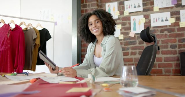 Fashion Designer Smiling at Desk in Creative Studio - Download Free Stock Images Pikwizard.com