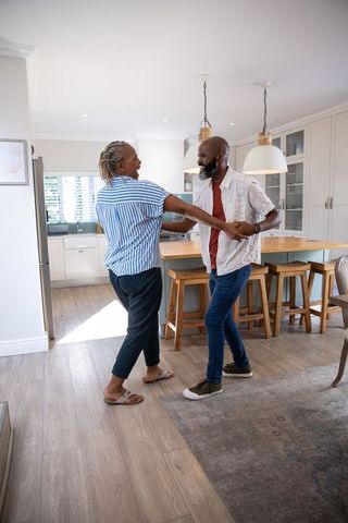 Senior African American Couple Dancing in Stylish Home Kitchen