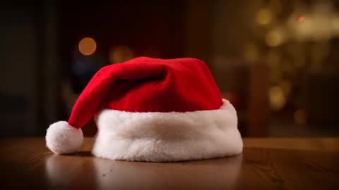 Santa Hat Resting on Wooden Table with Warm Bokeh Lights, Calm Holiday Video Clip