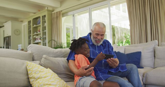 Grandfather and Grandchild Enjoying Time Together on Sofa with Digital Tablet - Download Free Stock Images Pikwizard.com