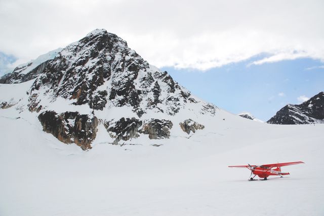 Red Plane Parked on Snow-Covered Mountain Landscape - Download Free Stock Photos Pikwizard.com