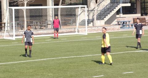 Youth soccer players competing intently on bright day