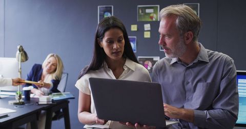 Diverse Business Professionals Collaborating on Laptop in Modern Office - Download Free Stock Images Pikwizard.com