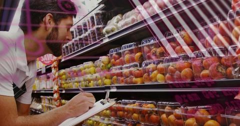 Produce inspector checking fruit for quality control in grocery store