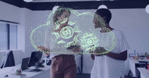 Colleagues interacting with cloud hologram in tech office