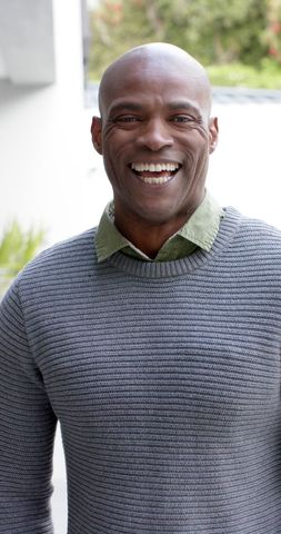 Smiling african american man in casual sweater outdoors
