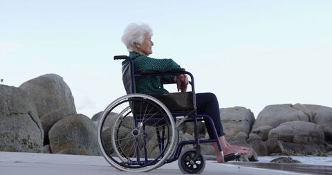 Senior Woman in Wheelchair Enjoying View at Beachfront