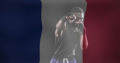 Focused boxer shadowed behind french flag
