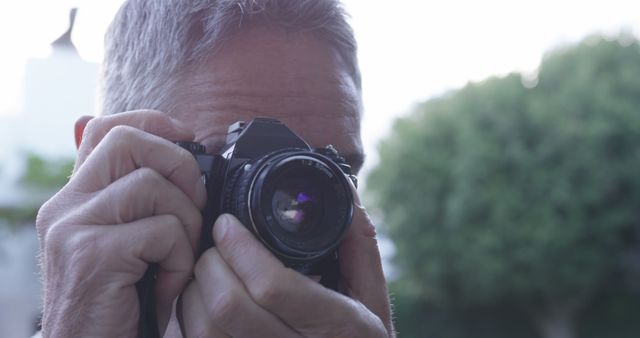 Closeup Man Taking Photo with Vintage Camera Outdoors - Download Free Stock Images Pikwizard.com