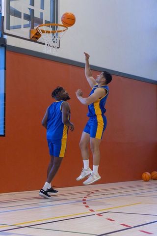Dynamic Basketball Players in Action on Indoor Court